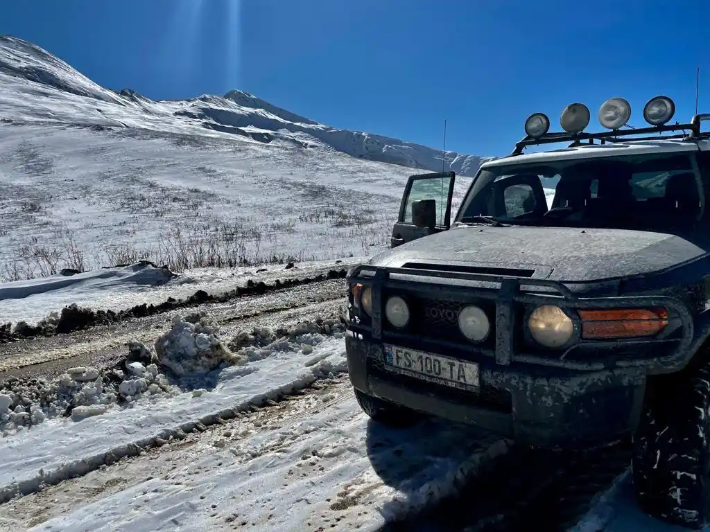 FSTA 4x4 rental car on a snowy mountain road in Georgia